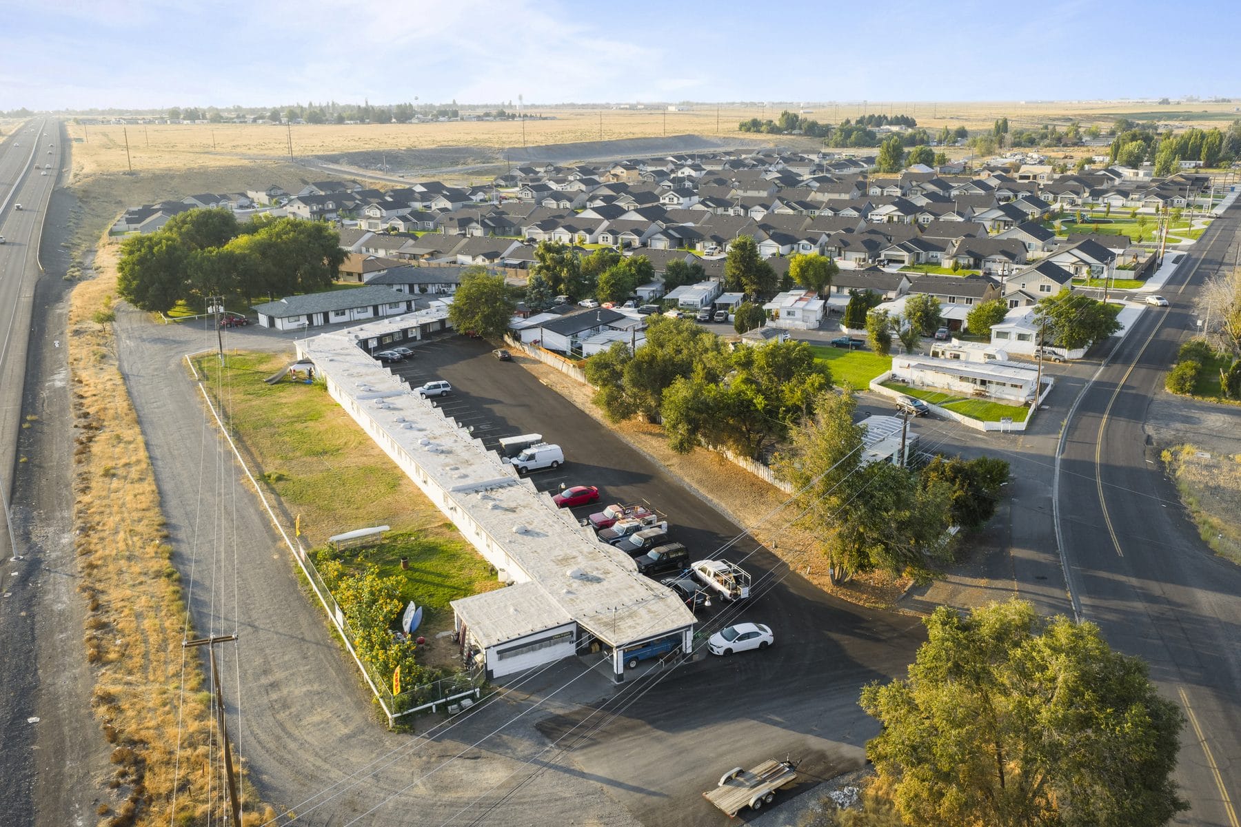 Golden-hour aerial view of a renovated apartment community in Moses Lake, Washington
